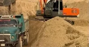 Excavator loading a truck at the Al-Nassaf quarry